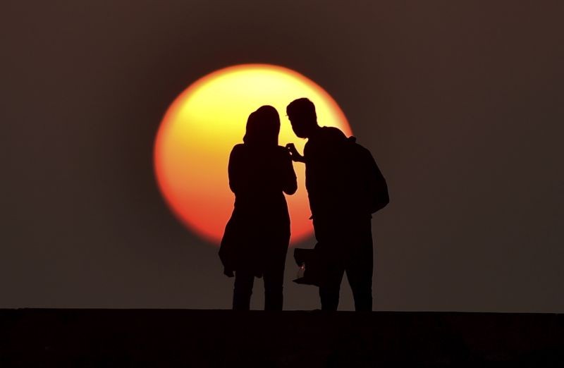 Chennai: People silhouetted against the setting sun at Broken bridge, in Chennai, Sunday, Jan. 31, 2021. (PTI Photo/R Senthil Kumar)